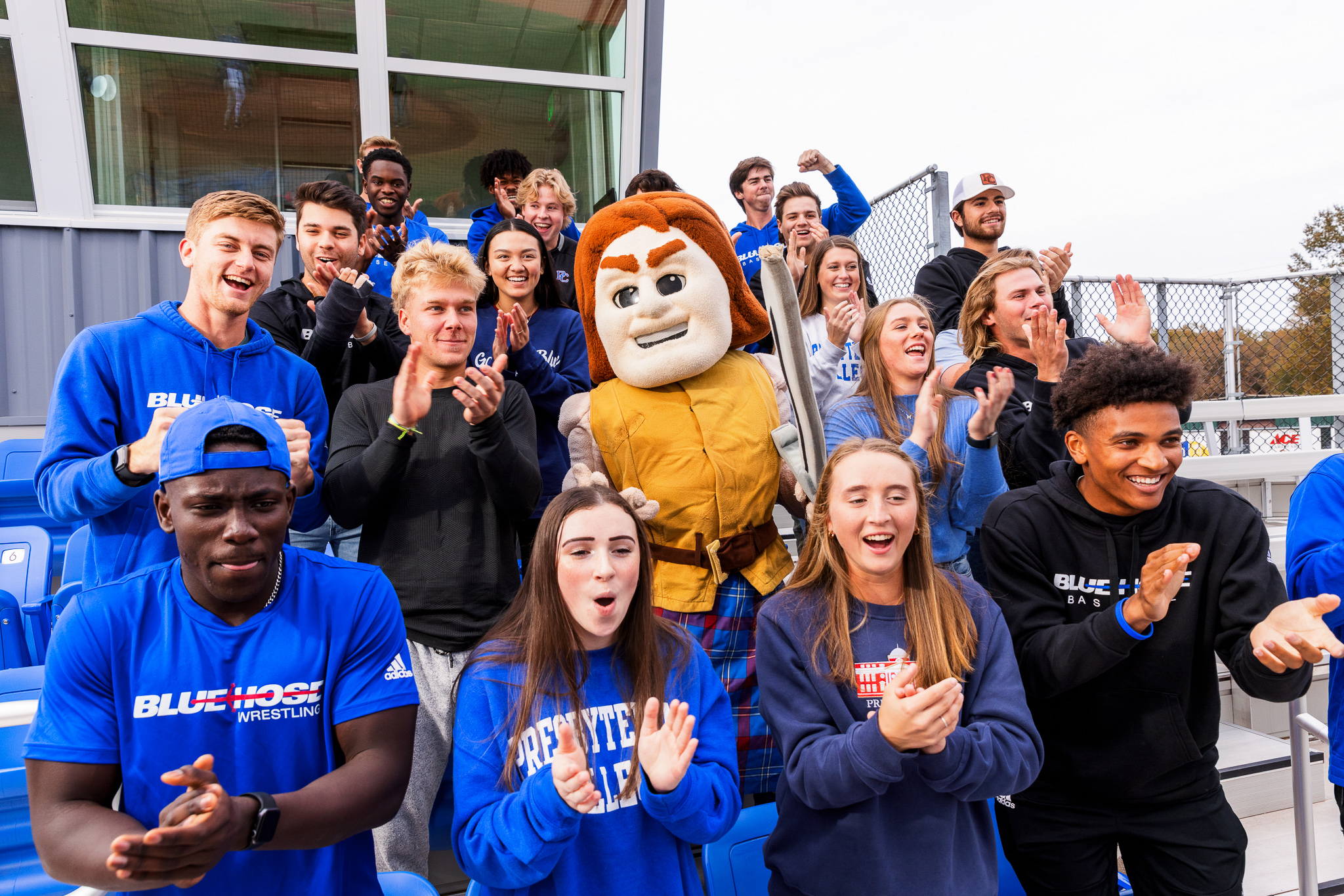 PC student athletes cheering with our mascot, Scotty.