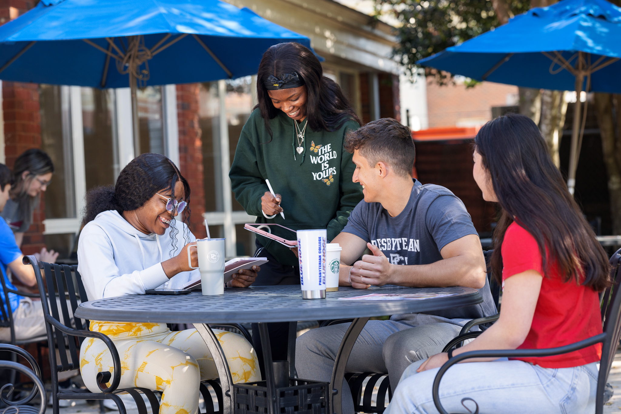 Group of students at an outdoor table at Springs Student Center.