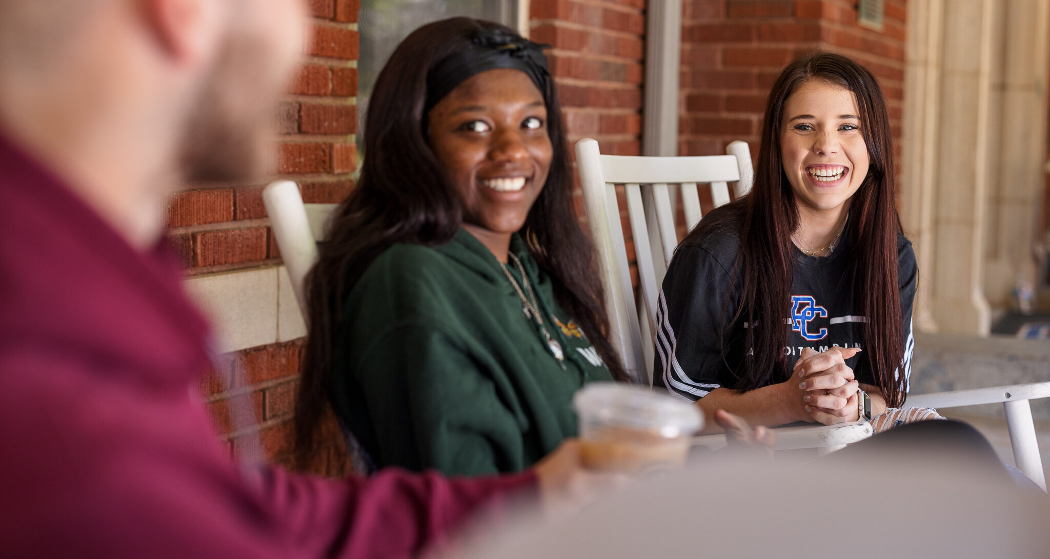 Presbyterian College students laughing outside of Springs Student Center.