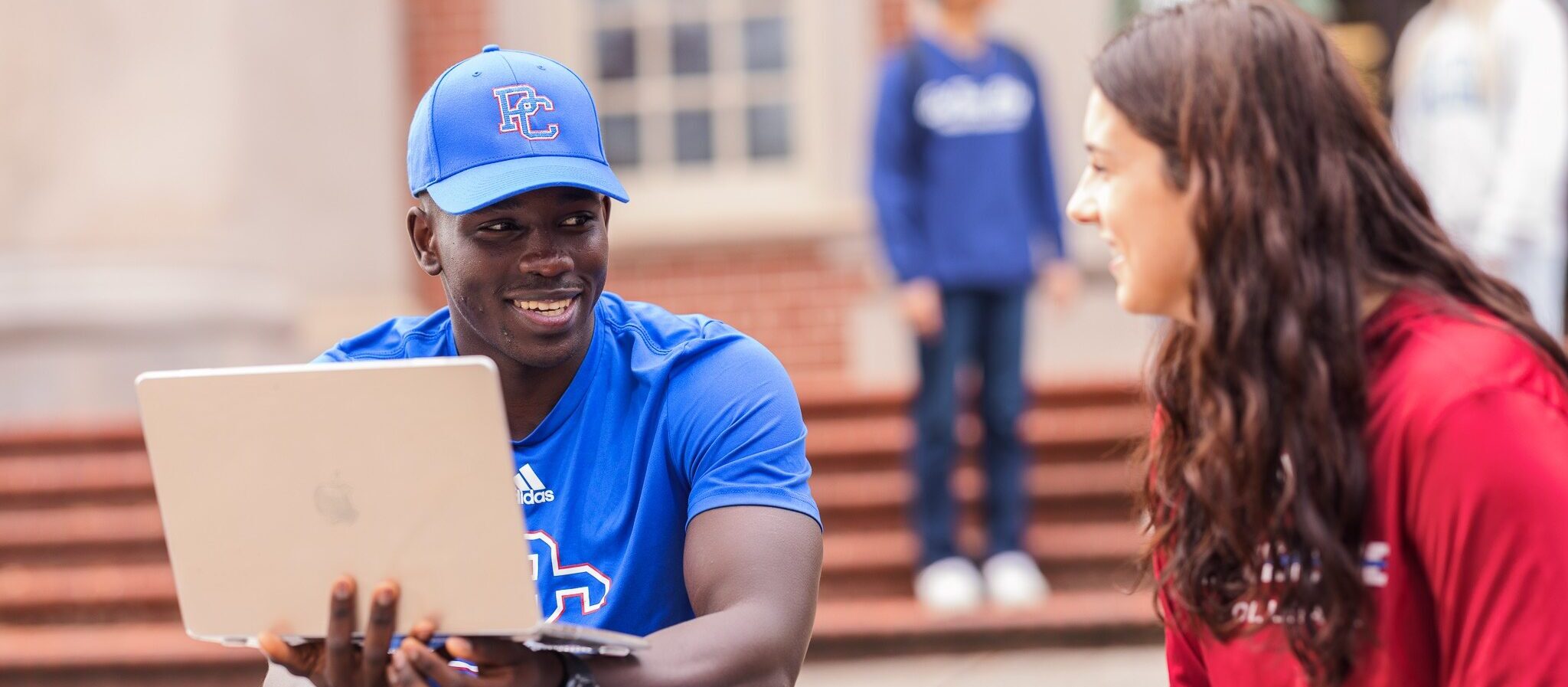 Presby students studying outside with laptop