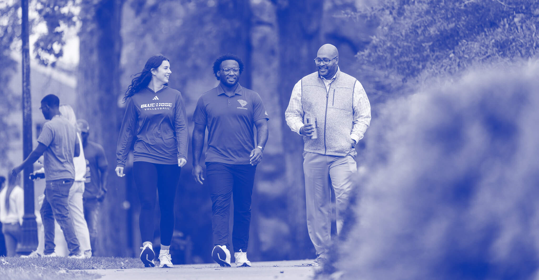 Professor, Dr. Will Harris and two students walk on the campus of Presbyterian College