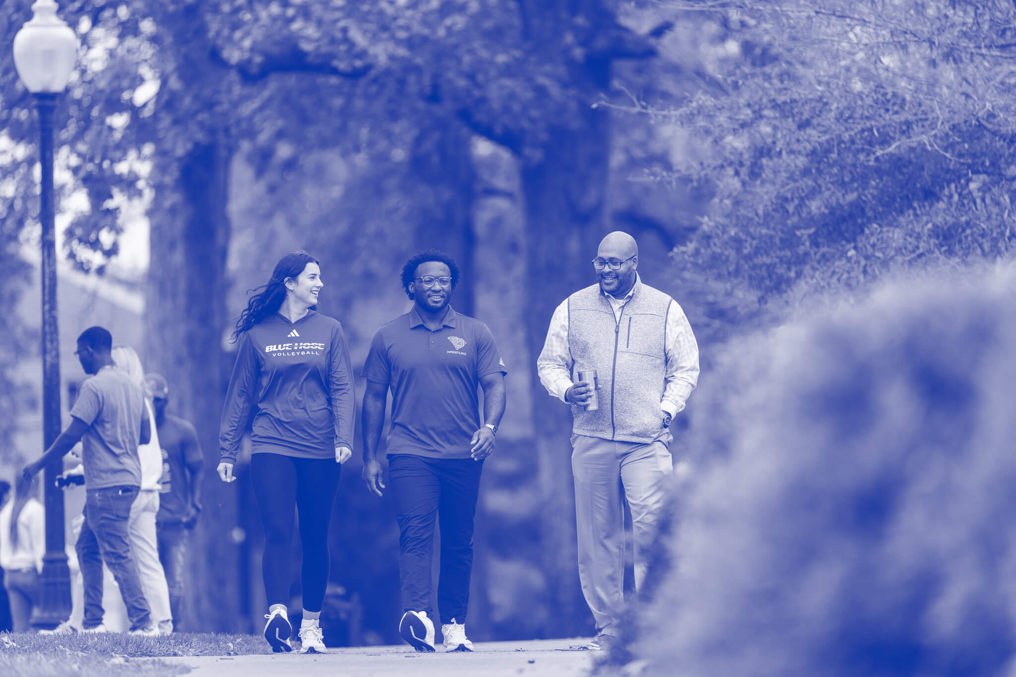 Professor, Dr. Will Harris and two students walk on the campus of Presbyterian College