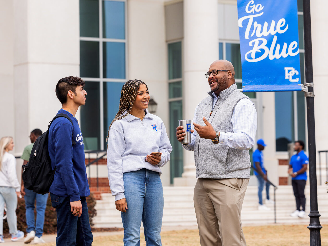 Presbyterian College students talking with Dr. Will Harris outside of Neville Hall.