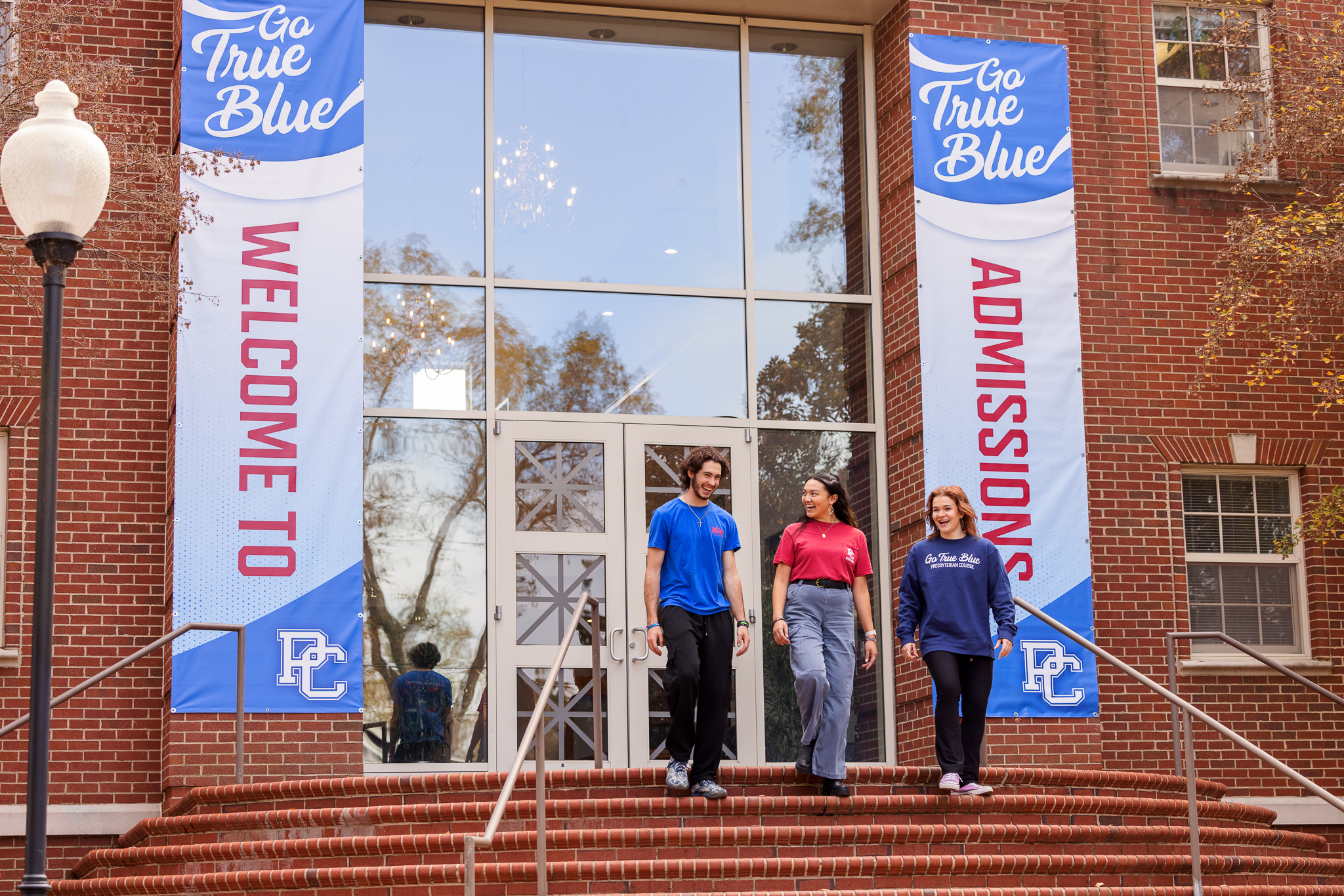 Presbyterian College students walking out of the Admissions building.