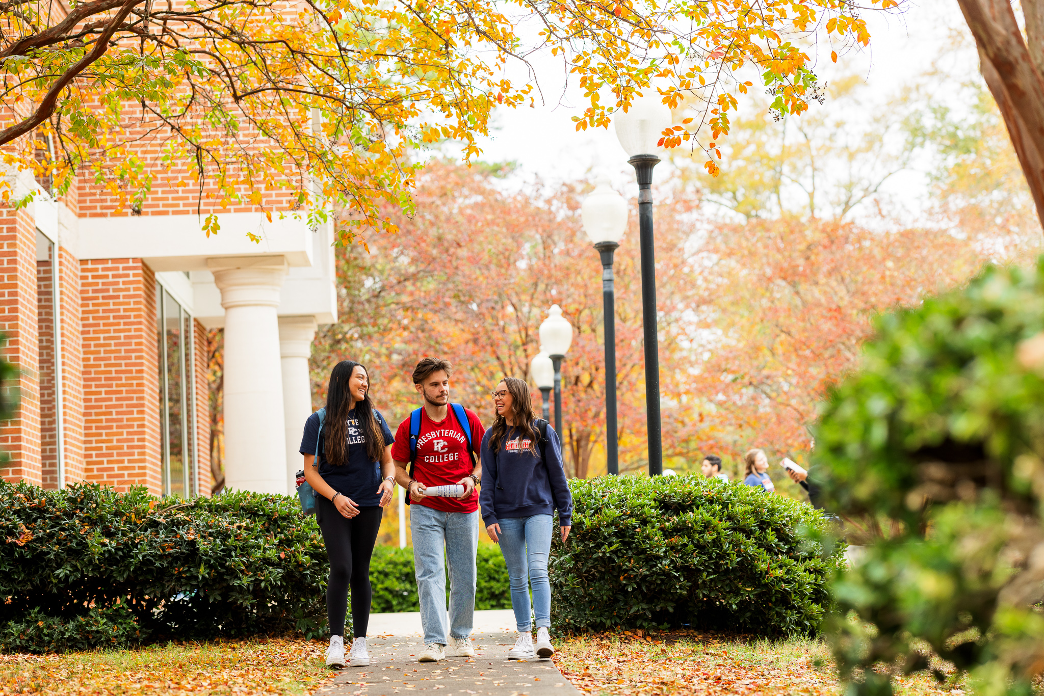 Presbyterian College students walking through campus in the fall.