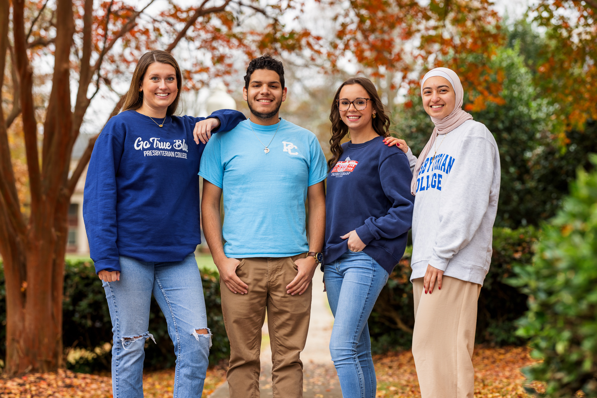 Presbyterian College students posing for a picture on campus in the fall.
