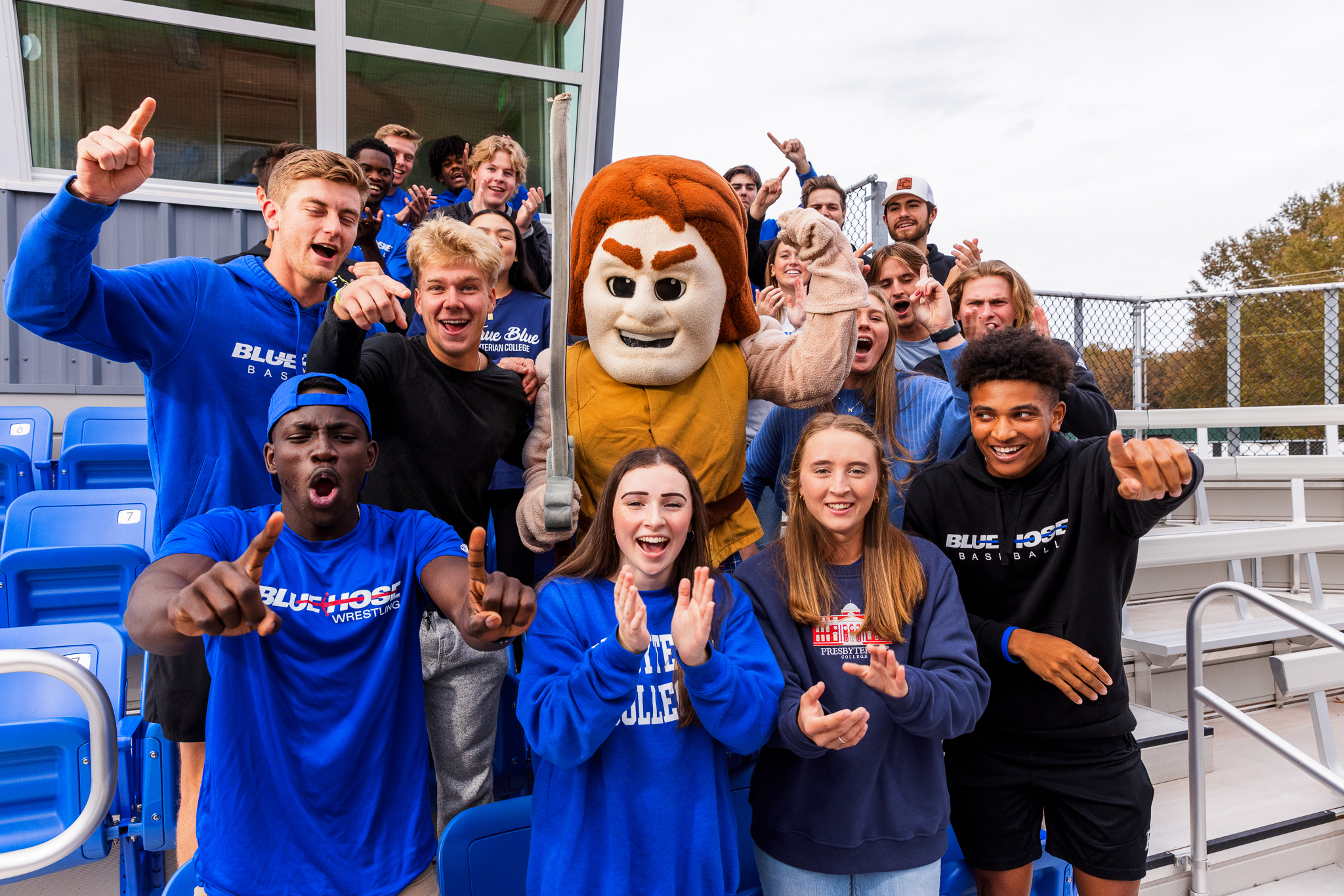 Presbyterian College student athletes cheering with our mascot, Scotty the Scotsman.