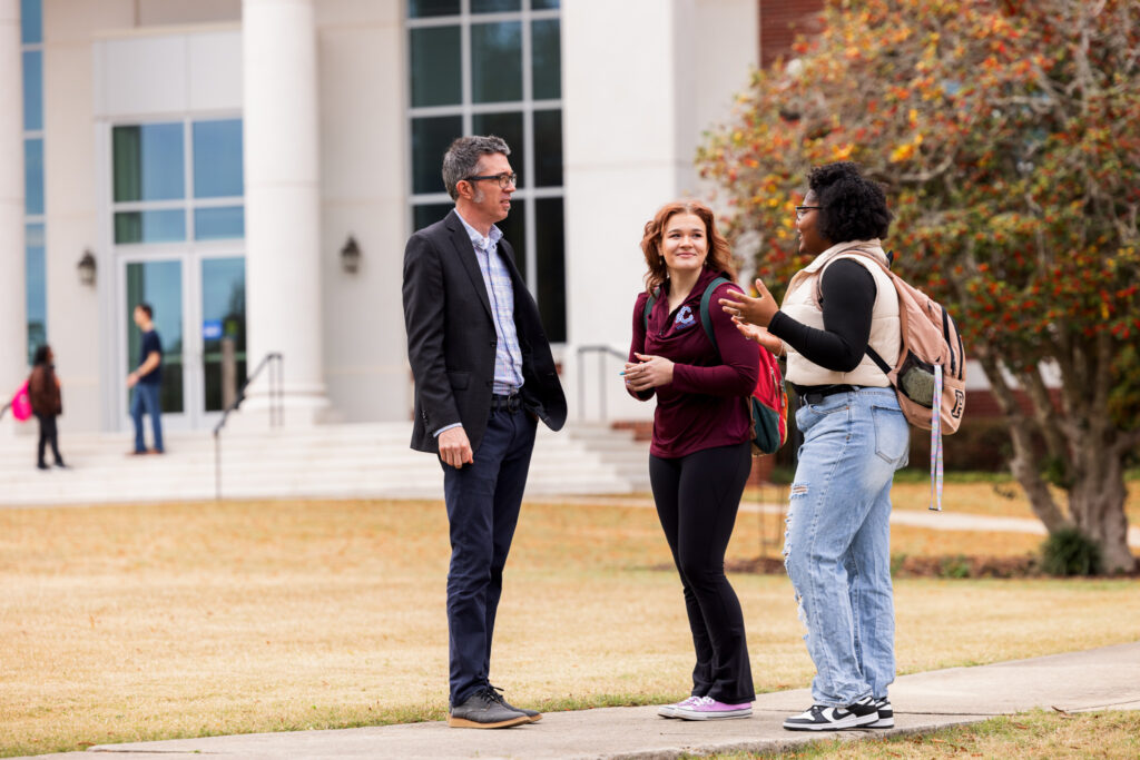 Dr. Philip Perdue talking with students.