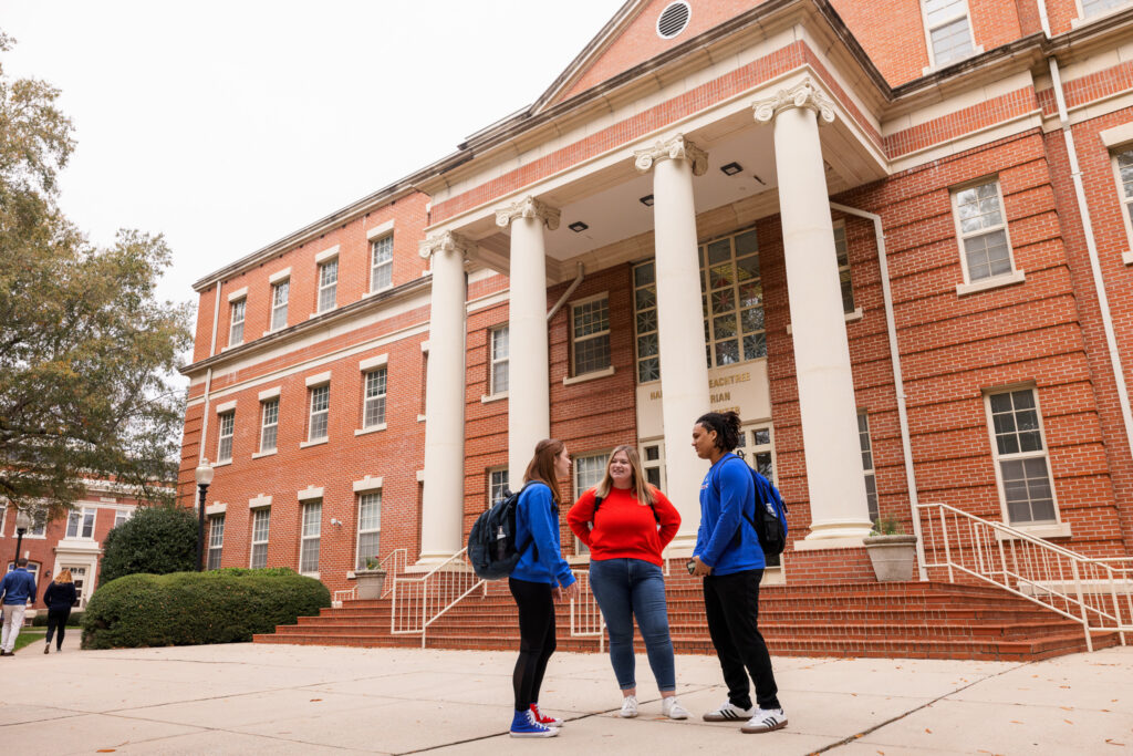 Presbyterian College students talking outside of Harrington Peachtree building. 