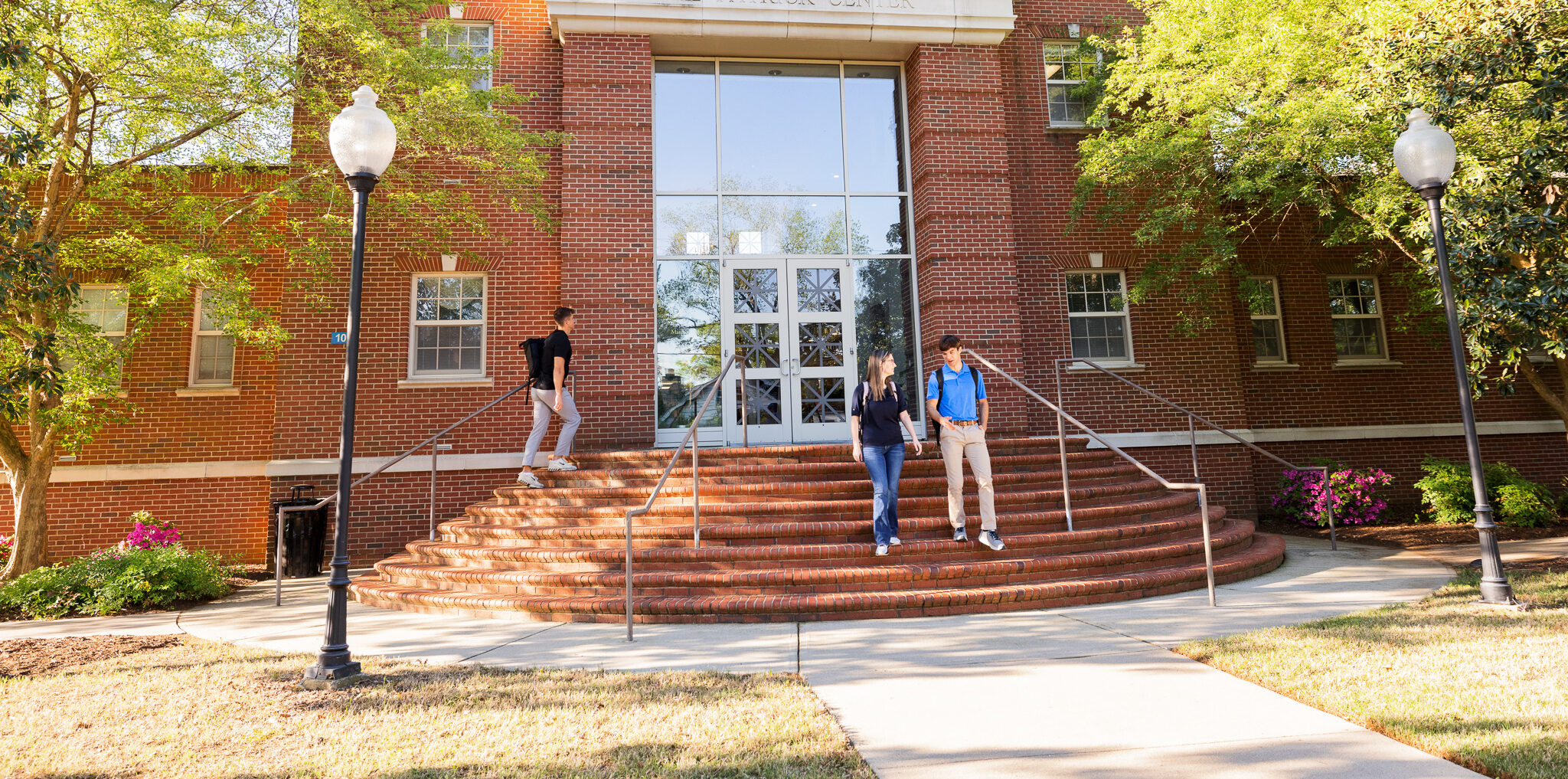 Presbyterian College students walking out of the Admissions building. 