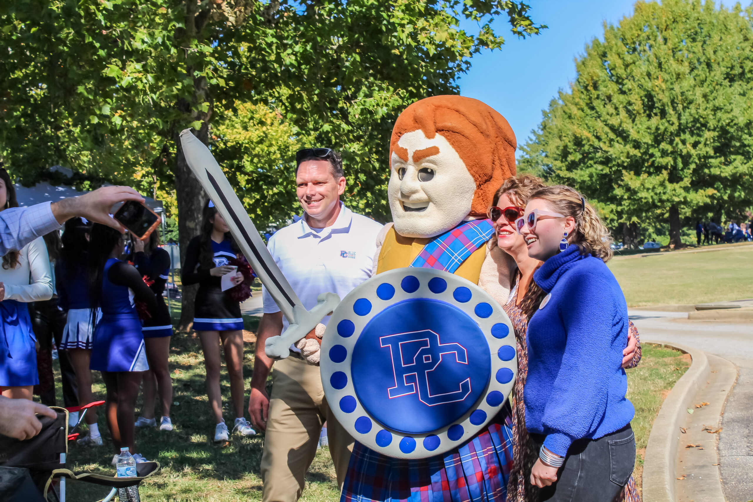 Presbyterian College fans posing with Scotty the Scotsman.
