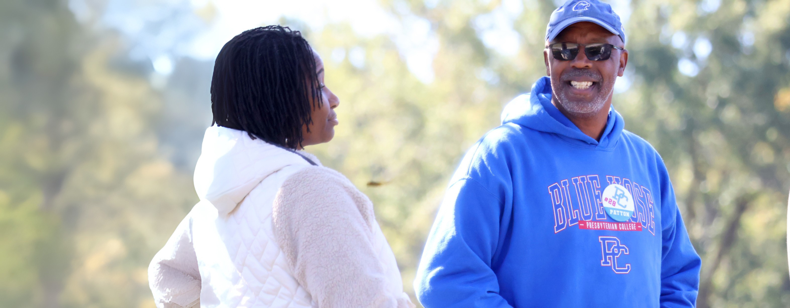Presbyterian College alumni laughing at a tailgate.
