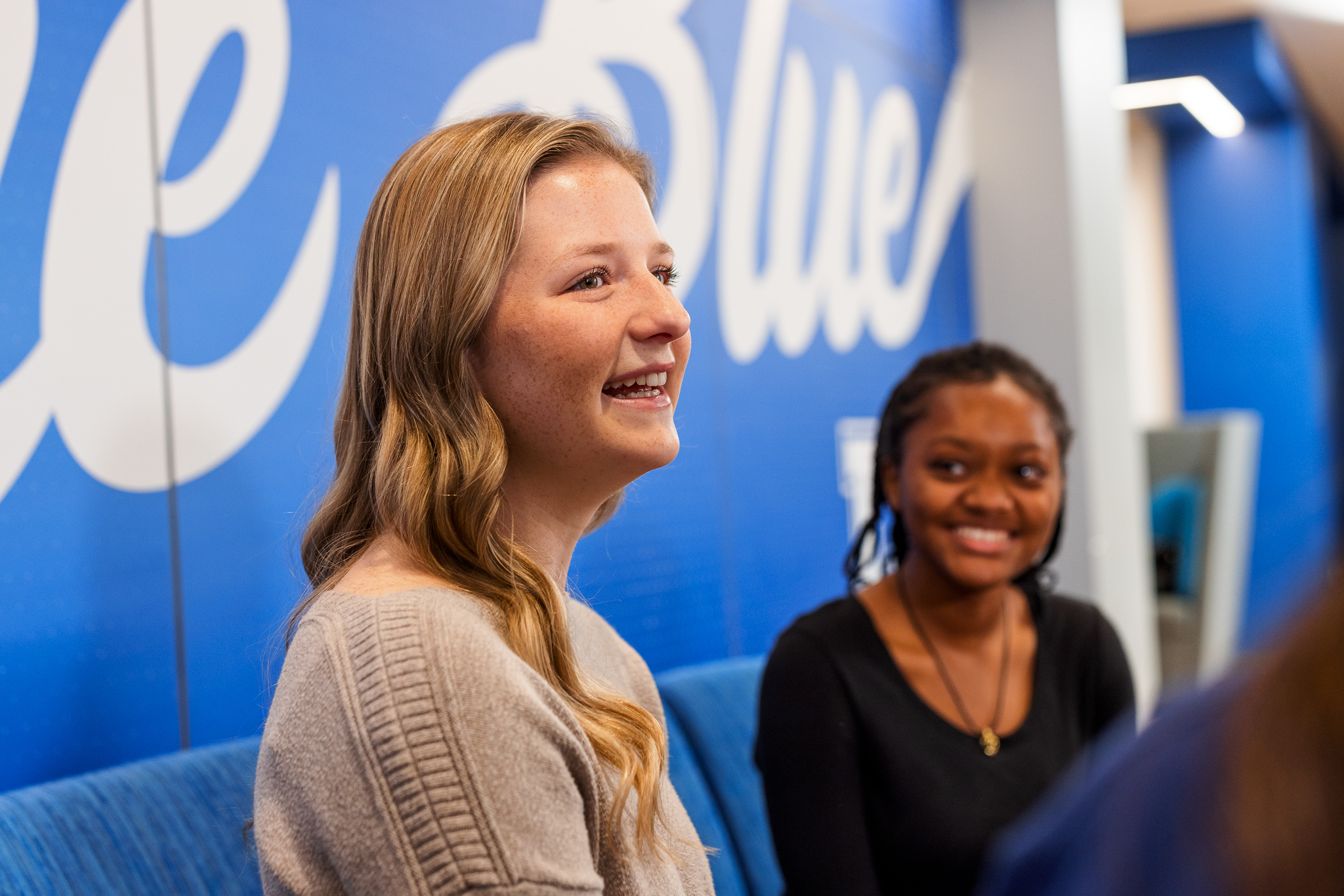 Two Presbyterian College students smiling in Springs Student Center.