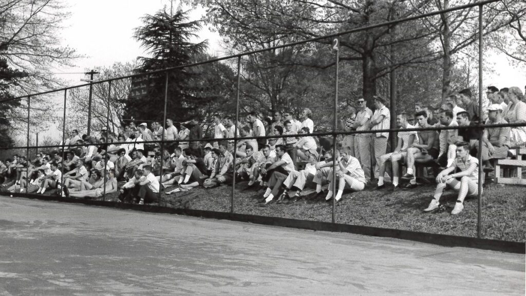 An archived photo of spectators watching a tennis match from the 1950s at Presbyterian College's historic Callaway Courts.