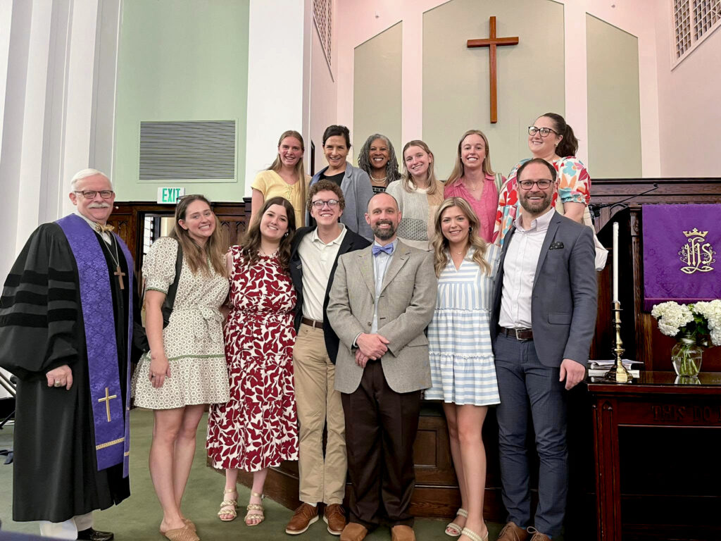 PC students and spiritual life staff at. a church taking a group photo. 