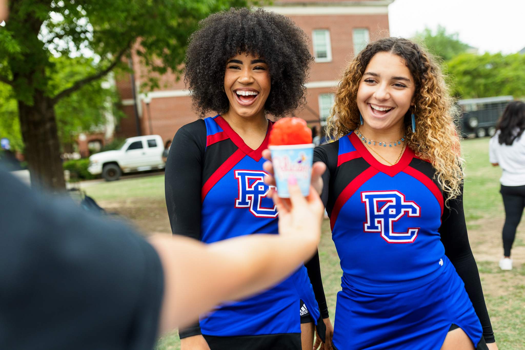 Presbyterian College cheerleaders posing for a picture with a snow cone.