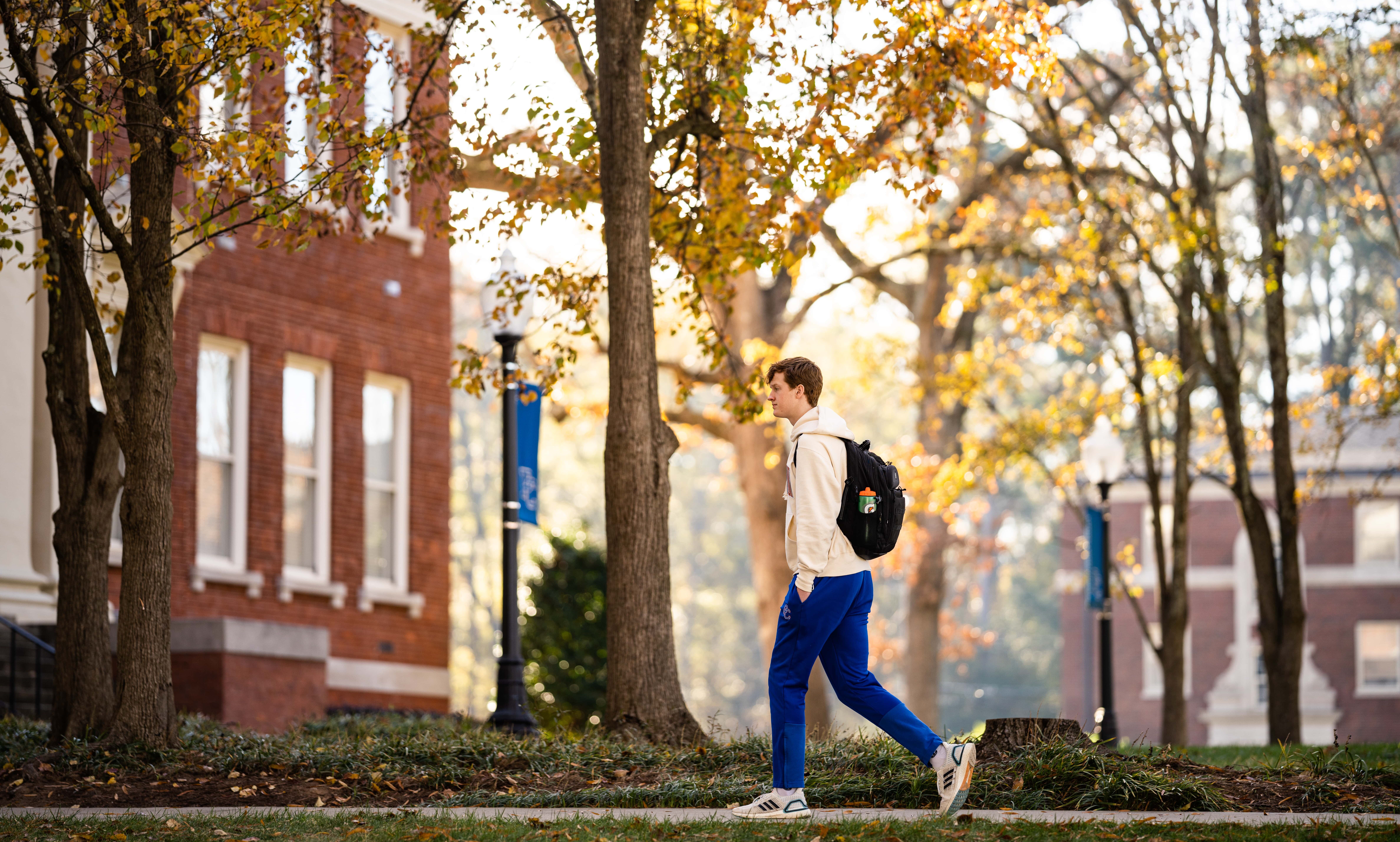 Presbyterian College Student walking on campus.