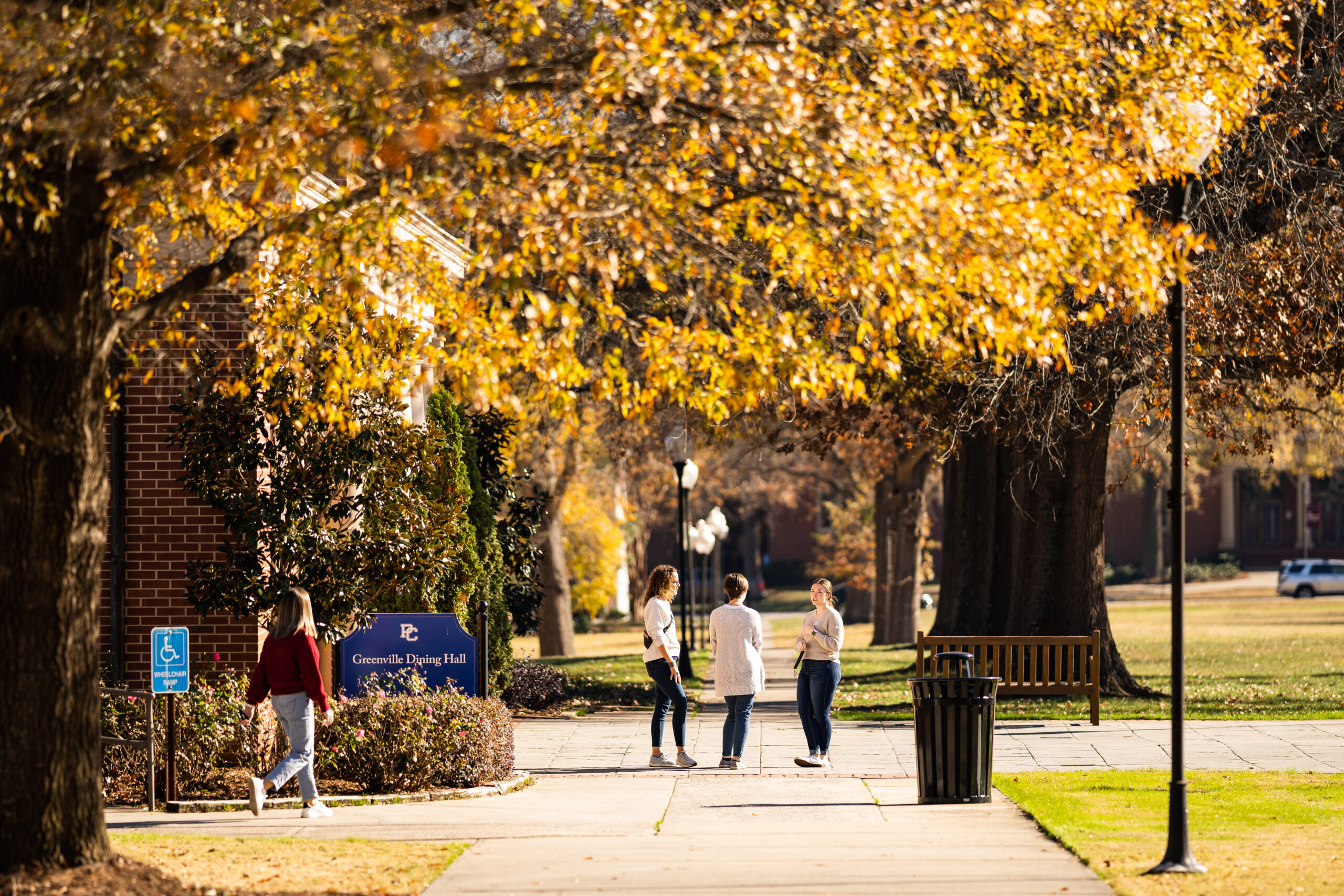 Presbyterian College students walking through campus in the fall.