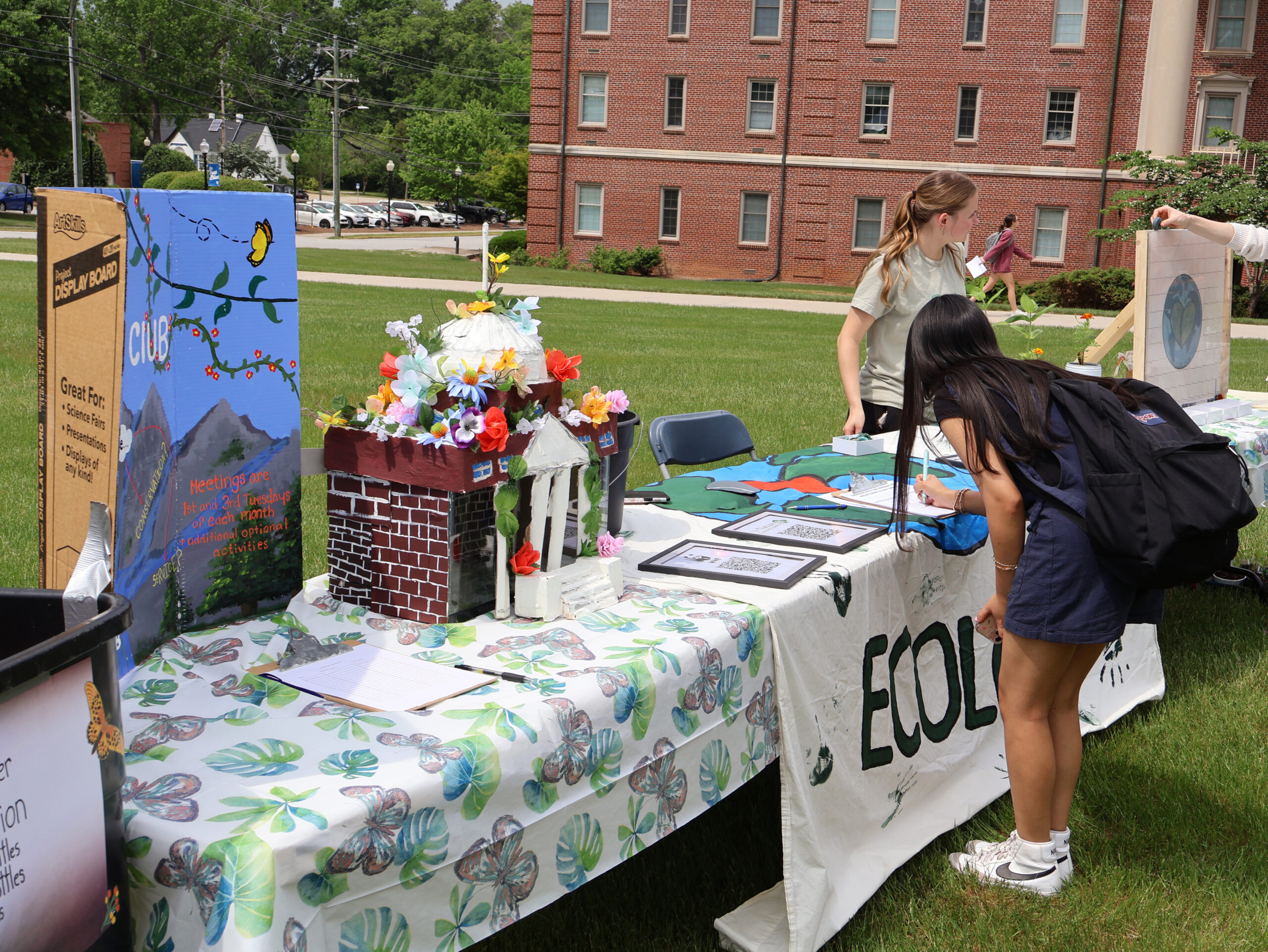 A student signing up for a club at our Earth Day ceremony.