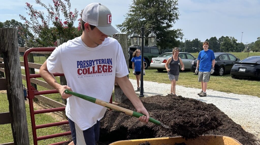 Presbyterian College student volunteers work at an equestrian center as part of Fall Service Day on Sept. 26.