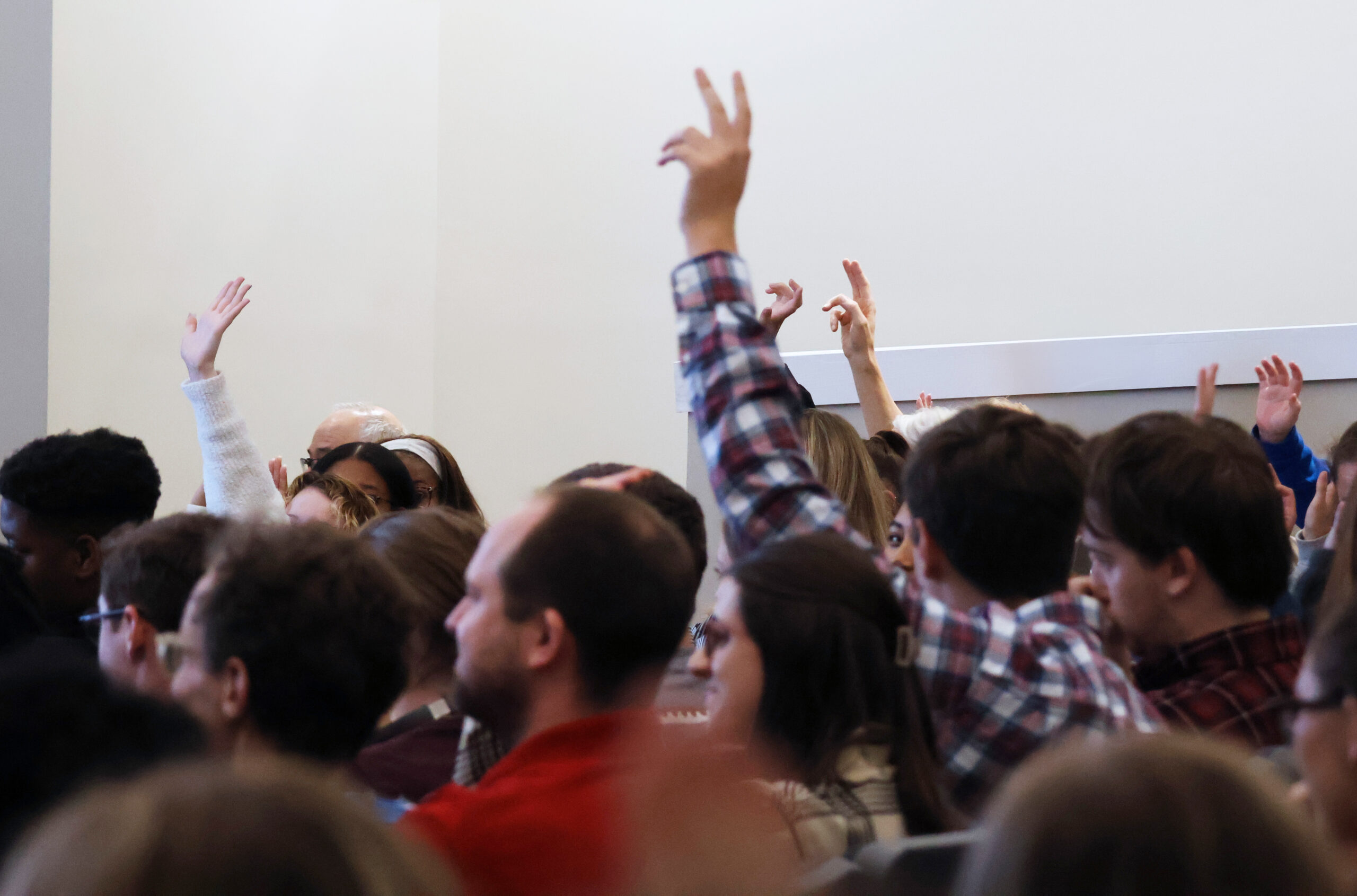 Students raising their hands at one of our Civil Conversations panels.