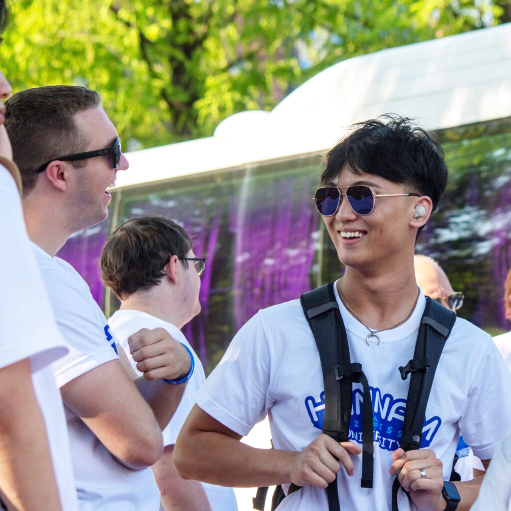 A Presbyterian College student smiling and talking with a friend.