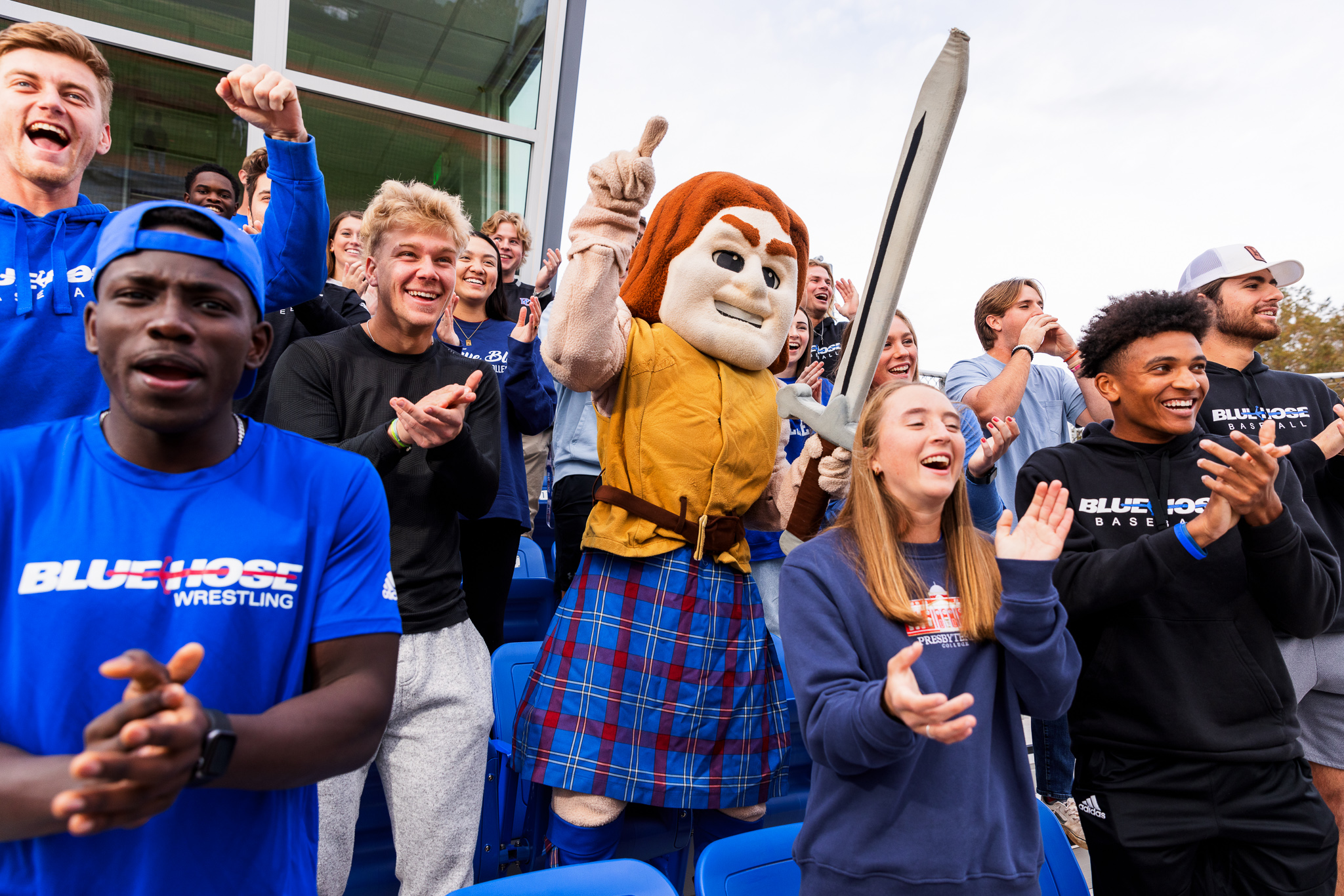 Presbyterian College student-athletes cheering with Scotty the Scotsman.