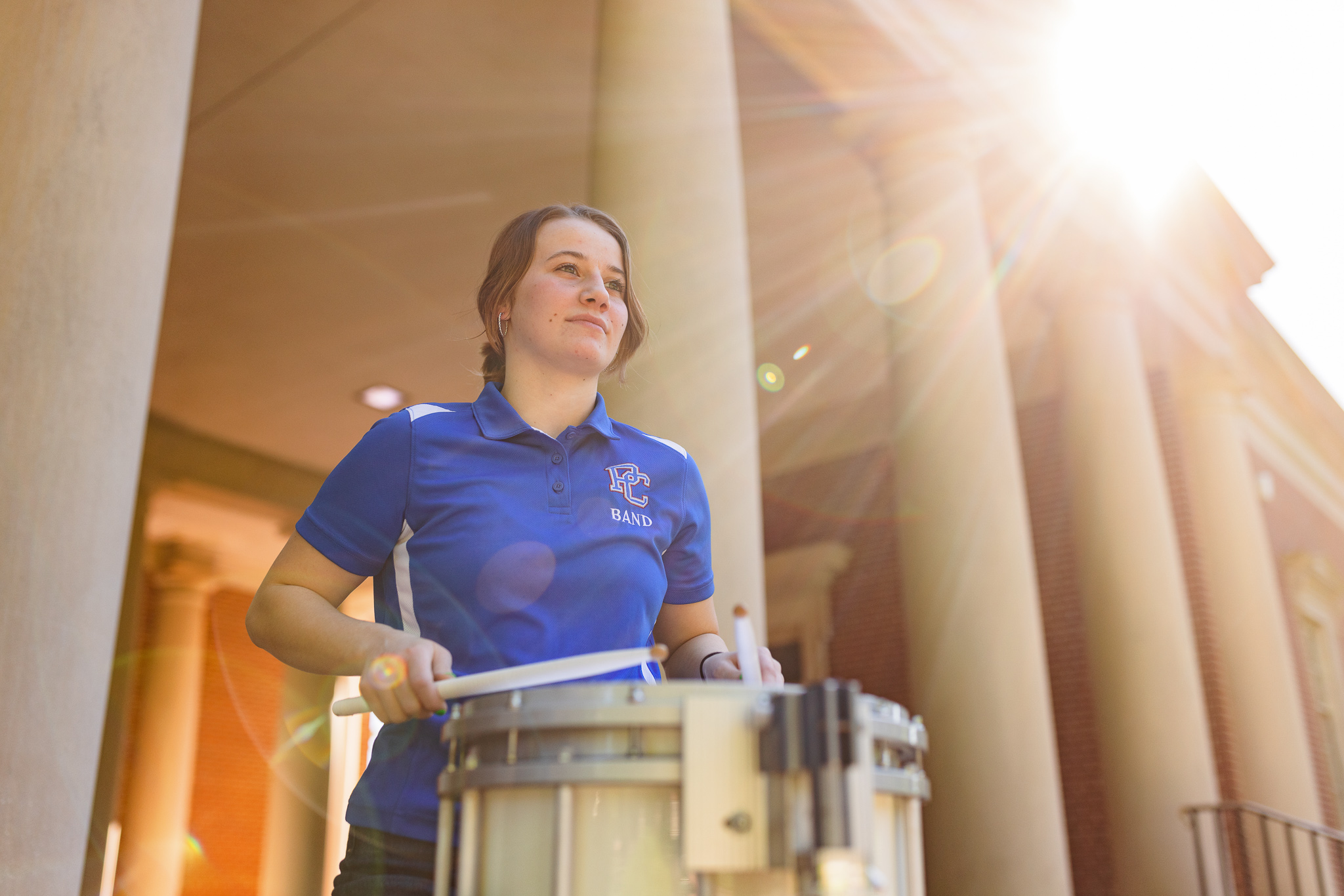 Presbyterian College student playing the drums outside of Belk Auditorium.