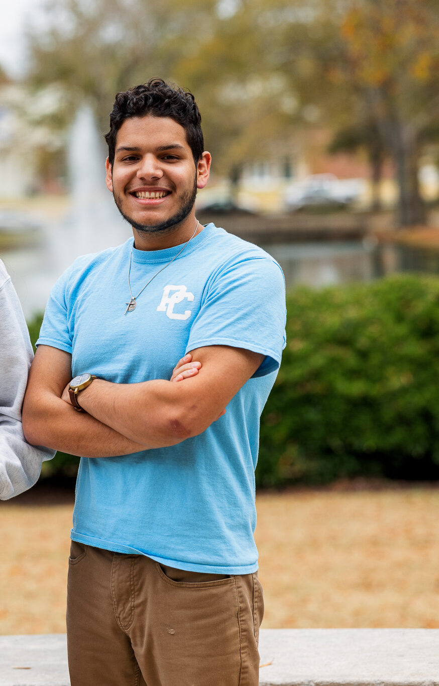 Three Presbyterian College students pose for a picture on campus.