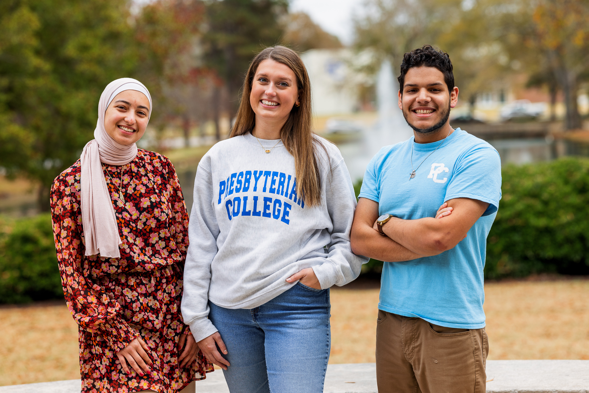Three Presbyterian College students pose for a picture on campus.