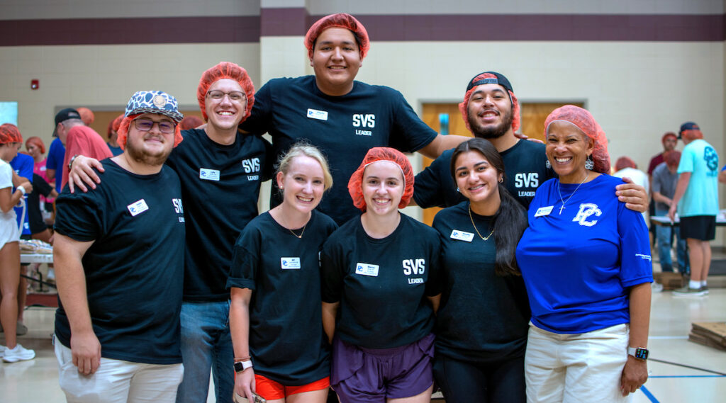Student Volunteer Services leaders at the Rise Against Hunger event with the Rev. Dr. British Hyrams, Jack and Jane Presseau Associate Chaplain.