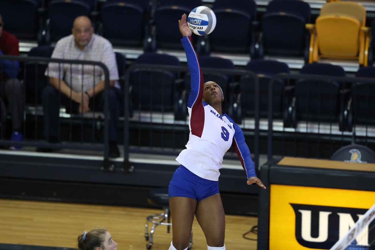 Trinity Williams spiking a volleyball during a match.