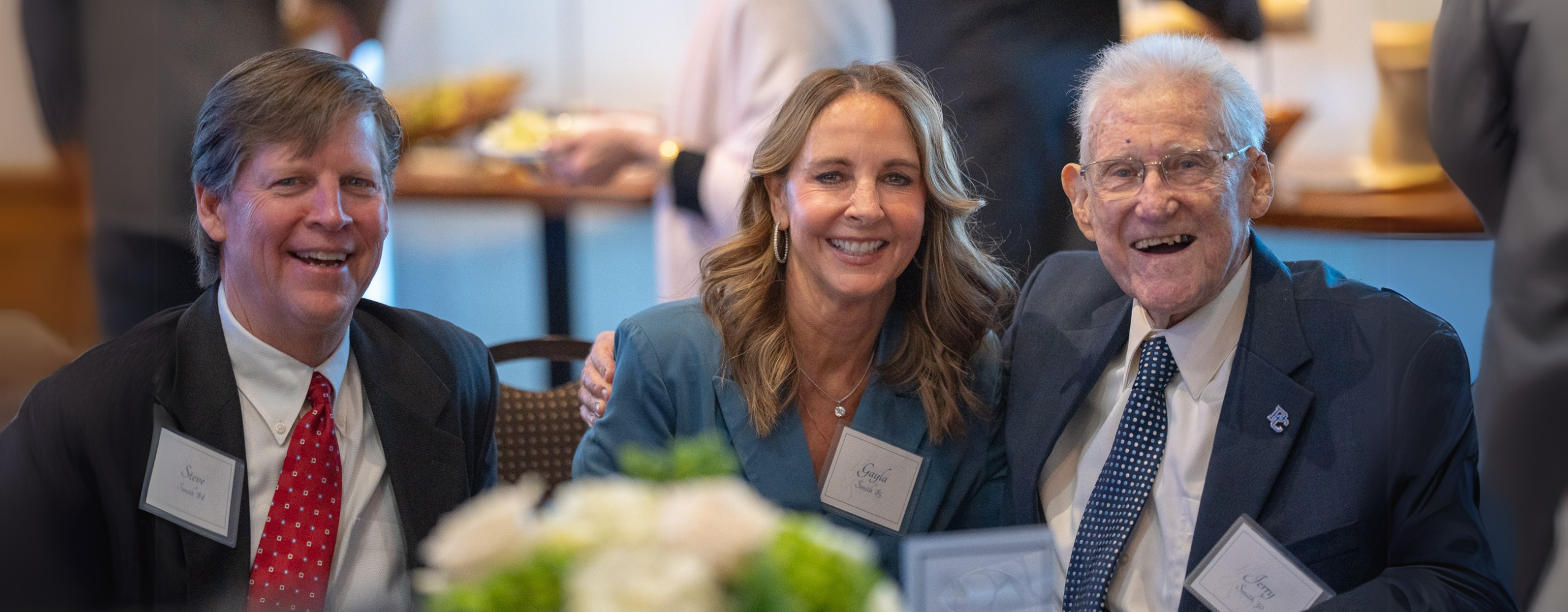 Presbyterian College alumni smiling for a photo at a gala.